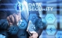 A man in a suit is pointing at data security icons.