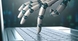 Picture of humanoid fingers typing on keyboard